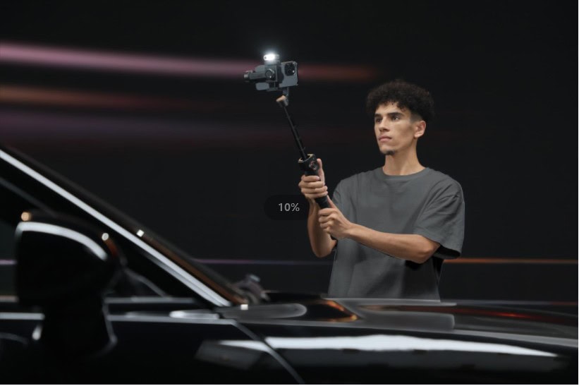 Hohem iPhone gimbal on extension stick Photo of a person using Hohem iSteady v7 iPhone gimbal with extension rod