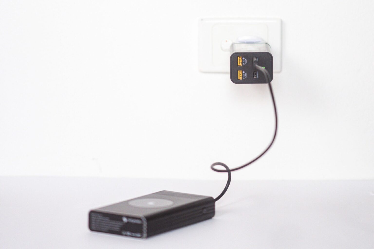 Plugged charger charging a device.