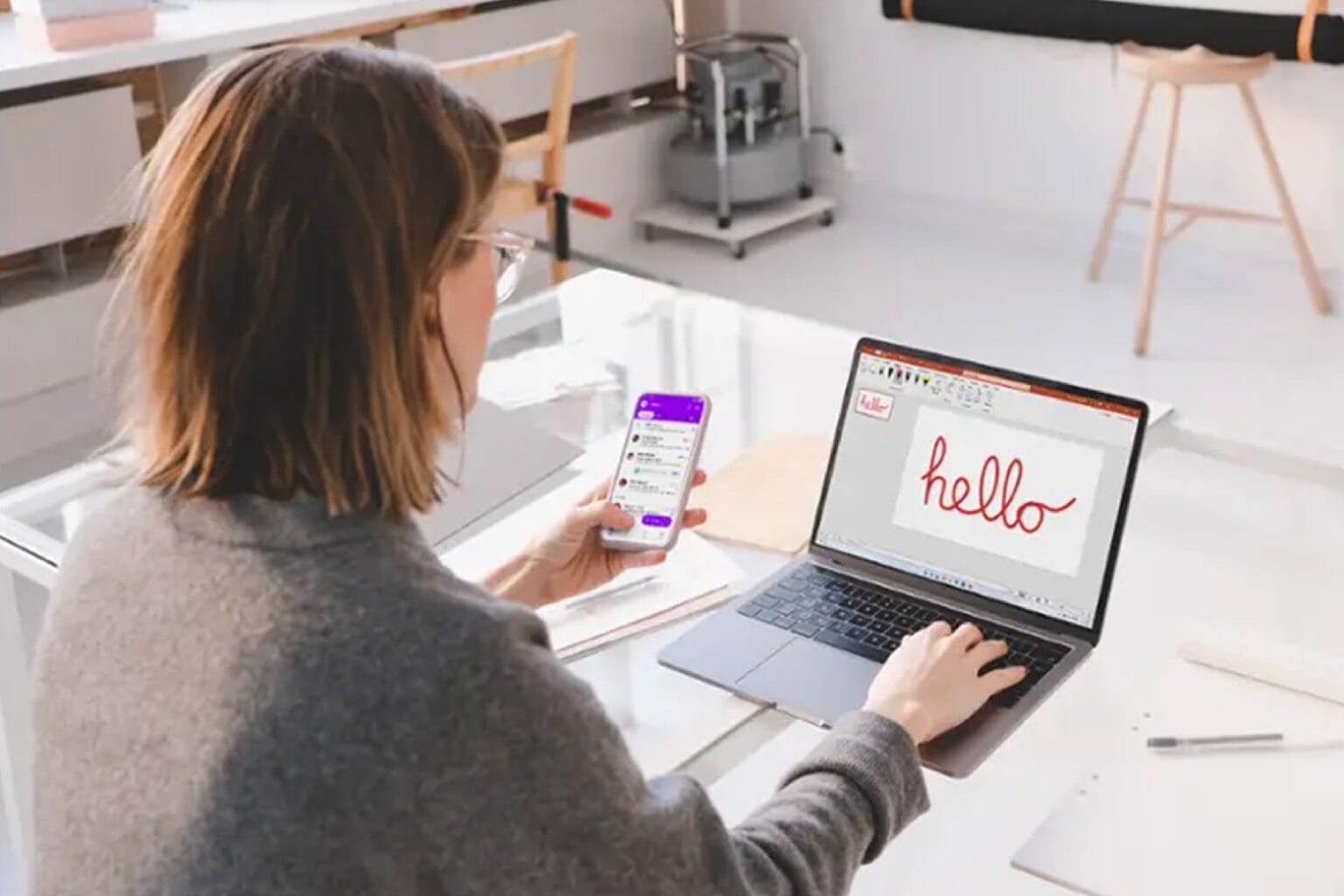 Woman using her laptop with one of Microsoft Office 2024 apps installed.
